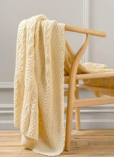 Cream Aran throw draped across chair